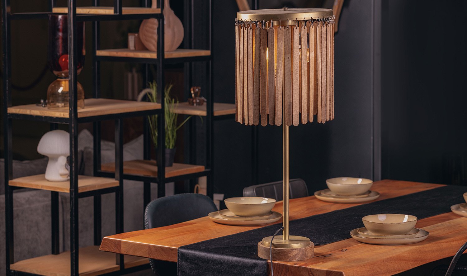 Sculptural lighting piece placed on a wooden dining table.